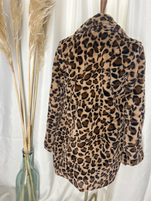 Classic leopard coat showcased on a mannequin with a gorgeous neutral backdrop