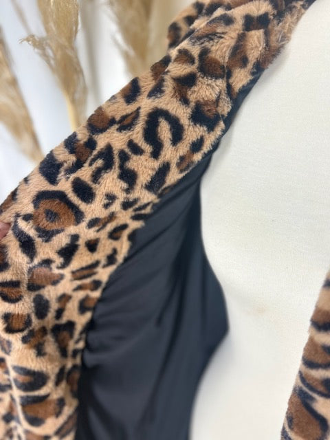Classic leopard coat showcased on a mannequin with a gorgeous neutral backdrop