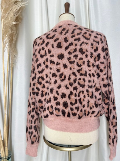 trendy stylish pink and brown leopard print sweater displayed on mannequin with pampas boho back drop
