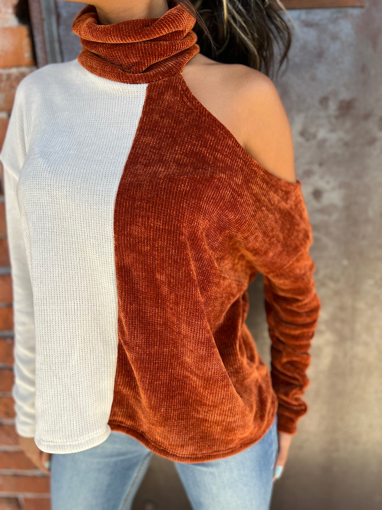 trendy girl posing in a cold shoulder sweater top