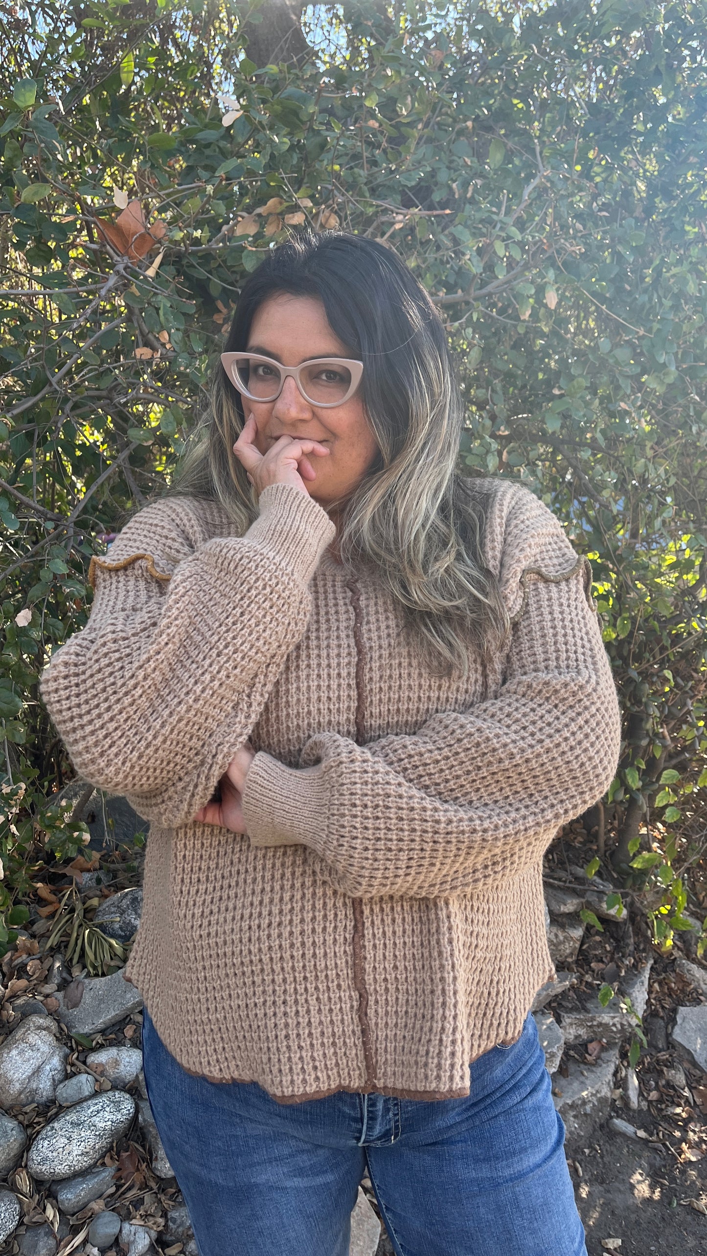 model wearing size large oversized hazel mocha knit sweater outside on a hike trail