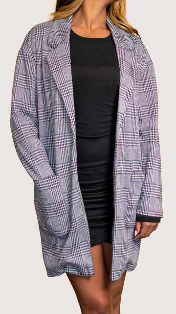 model wearing black and white plaid blazer worn with a black mini dress