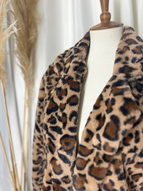 Classic leopard coat showcased on a mannequin with a gorgeous neutral backdrop