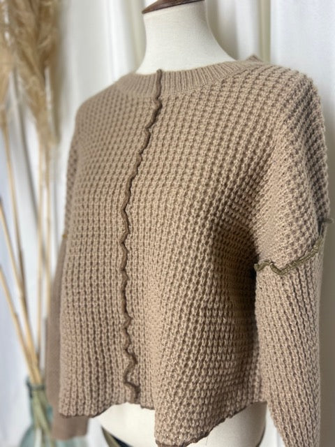 sideview of mocha waffle knit sweater to show off the contrast light olive stitching detail
